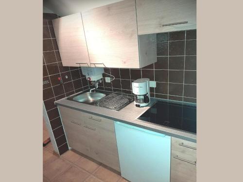 a kitchen with a sink and a coffee maker on the counter at Charmantes Ferienhaus in Skigebietsnähe in Schmallenberg