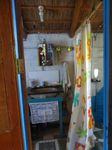 a bathroom with a sink and a shower curtain at la remansa in Neptunia