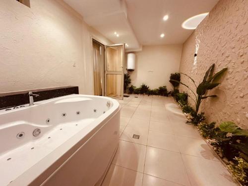 a large bathroom with a large tub in a room at Giza Pyramids Inn in Cairo