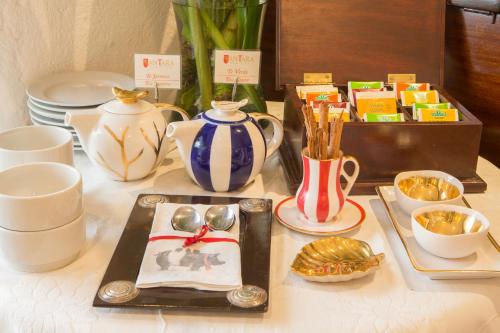 a table topped with plates and cups and a tray with spoons at Antara Hotel & Suites - Miraflores in Lima