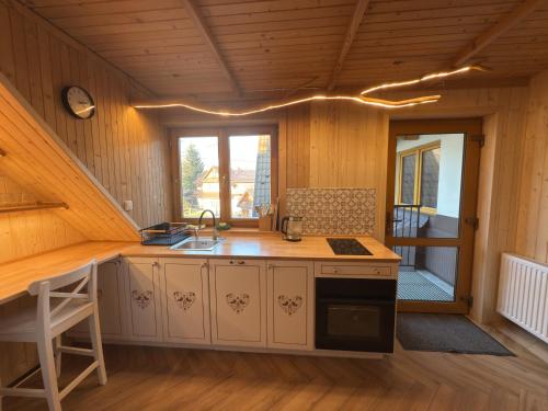 a kitchen with a sink and a stove in a room at Zakopane - Króle 16 in Zakopane
