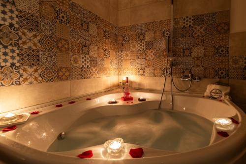 a bath tub with a candle in a bathroom at Il Borgo Guest House Subiaco in Subiaco