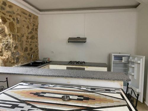 a kitchen with a stove and a counter top at Appartement Domaine Du Soleil Hammamet 