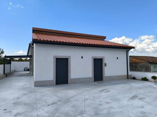 a large white building with two doors on it at Casa de Campelo in Vila Nova de Cerveira