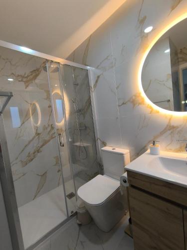 a bathroom with a shower and a toilet and a sink at Casa de Campelo in Vila Nova de Cerveira