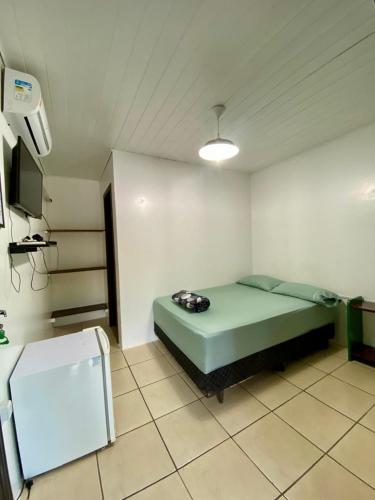 En eller flere senge i et værelse på Hospedaria aconchego 2