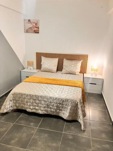 a bedroom with a bed with two nightstands and two tables at Tilys house in Capesterre-Belle-Eau