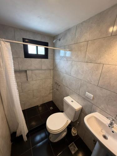 a bathroom with a toilet and a sink at Casa Alfonsina in Chapadmalal