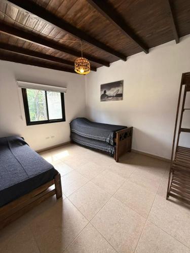 a bedroom with a bed and a chandelier at Casa Alfonsina in Chapadmalal