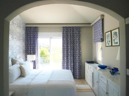 a bedroom with a large bed and a window at Pentathlon Villa Collection - Porto Cheli Private Pool Getaways in Porto Heli