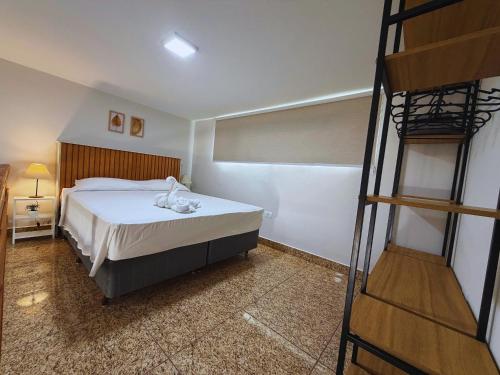 a bedroom with a bed and a bunk ladder at Cataratas Loft Residence in Foz do Iguaçu