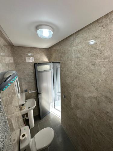 a bathroom with a toilet and a sink at Wavera Surf Camp in Imsouane