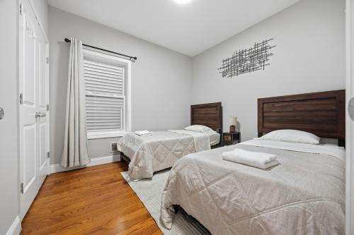 a bedroom with two beds and a window at 3 BR • Full Kitchen • Sleeps 8 in Jersey City