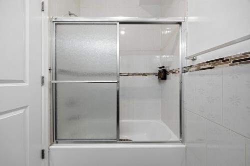 a shower with a glass door in a bathroom at 3 BR • Full Kitchen • Sleeps 8 in Jersey City