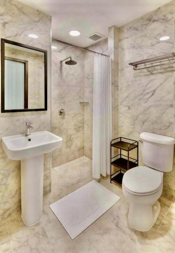 a bathroom with a toilet and a sink and a shower at Bright Sun Apartment with Pools in Rawai Beach