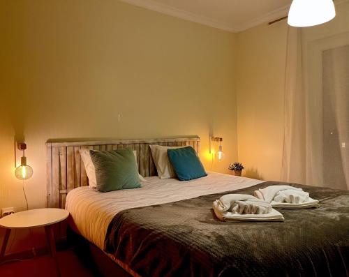 a bedroom with a bed with two towels on it at Casas do Mar - Baleal 1 - Sea House in Baleal