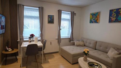 a living room with a couch and a table at Apartment in the heart of Esbjerg Center in Esbjerg