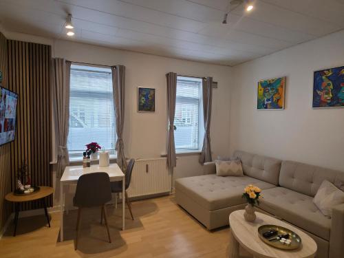 a living room with a couch and a table at Apartment in the heart of Esbjerg Center in Esbjerg