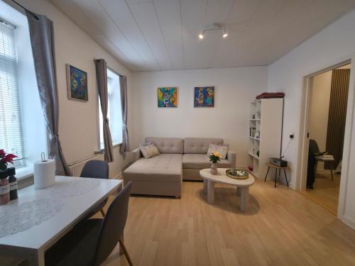 a living room with a couch and a table at Apartment in the heart of Esbjerg Center in Esbjerg