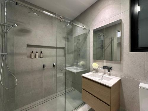 a bathroom with a glass shower and a sink at Seas the Day - Bay Stay in Tootgarook