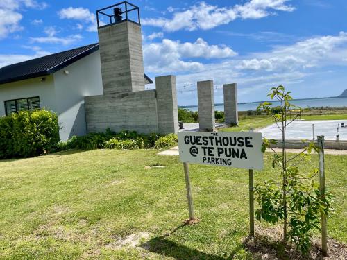 a sign in front of a church with a lighthouse at Guesthouse @ Te Puna in Tauranga