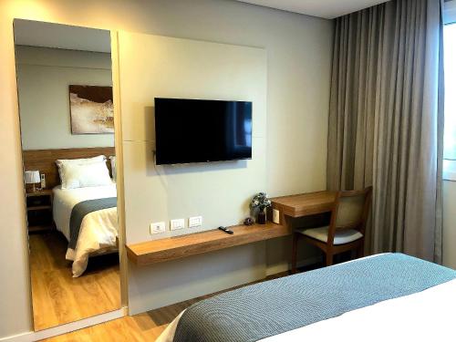 En eller flere senge i et værelse på Stilo Prime Flat com Hidro