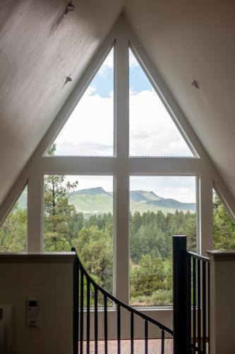 a large window in a house looking out at the mountains at A-frame 10 Min to Downtown Durango in Durango