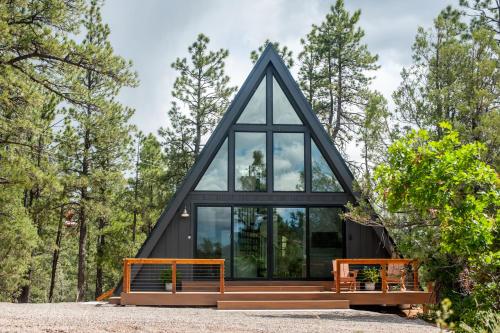 a frame house with a black roof and windows at A-frame 10 Min to Downtown Durango in Durango