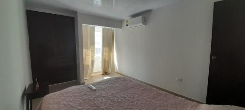 a bedroom with a bed and a large window at Hotel Cartagena antigua in Cartagena de Indias