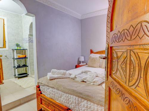 a bedroom with a bed and a walk in shower at Belle Maison Taghazout in Taghazout