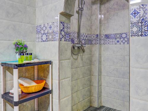 a bathroom with a shower with a glass door at Belle Maison Taghazout in Taghazout