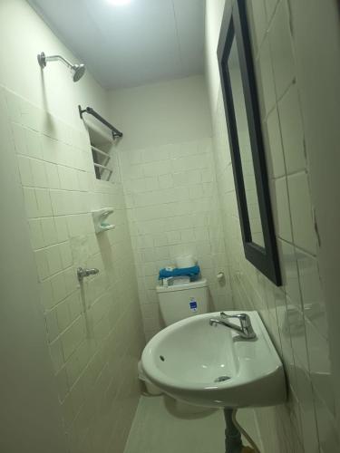 a bathroom with a sink and a toilet and a mirror at Hotel Cartagena antigua in Cartagena de Indias
