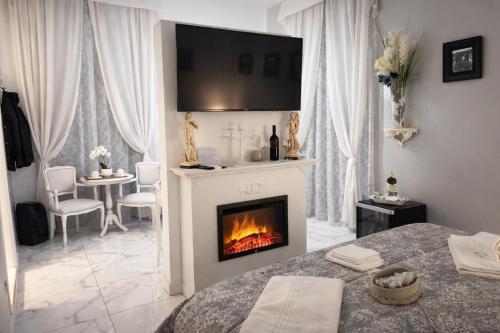 a white living room with a fireplace and a table at Barberini Dream in Rome