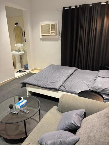 استديو بطابع هادي في الخبر: غرفة نوم بها سرير وطاولة وأريكة