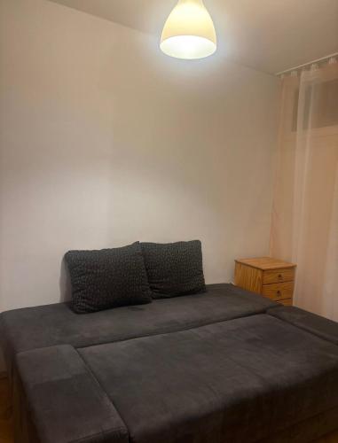 a bedroom with a bed and a light on the wall at Zakątek in Warsaw