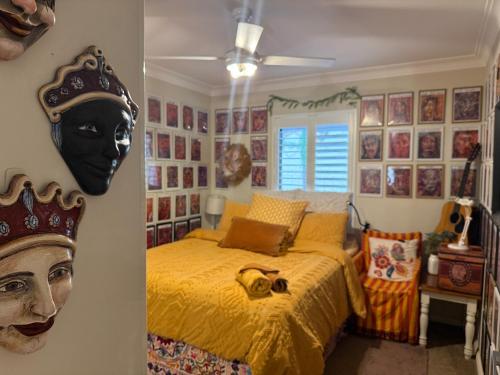 a bedroom with a bed with a black mask on the wall at NEWTOWN - HEART OF - Bohemian Creative Space in Sydney