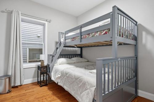 a bedroom with a bunk bed with a ladder at 4 BR • Vaulted Living • Sleeps 11 in Jersey City