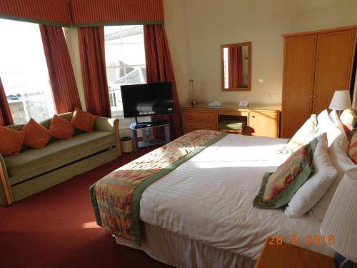 a hotel room with a bed and a couch at Horizon Hotel in Ayr