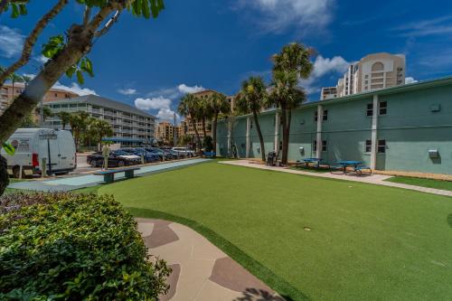 a large artificial lawn in front of a building at Abode Beach House in Clearwater Beach