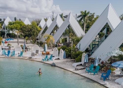 a woman in the water at a pool at a resort at Pyramids in Florida in Estero
