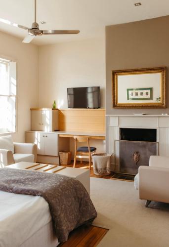 a bedroom with a bed and a fireplace at The Woodbridge Waterfront Rooms in New Norfolk