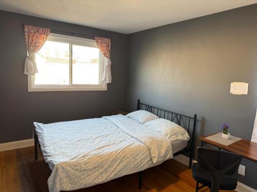 a bedroom with a bed and a window and a desk at R2 Near to Towson and Morgan University in Parkville