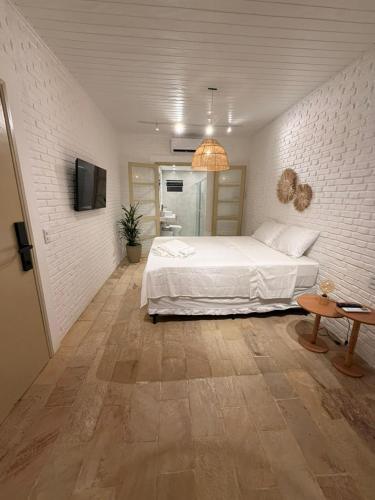 En eller flere senge i et værelse på Kanga Suítes - Aquário