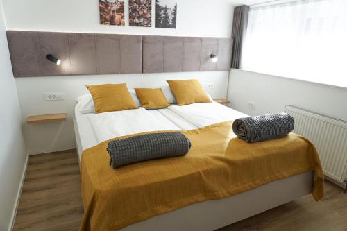 a bedroom with a bed with two pillows on it at Gostisce Ulipi in Slovenske Konjice