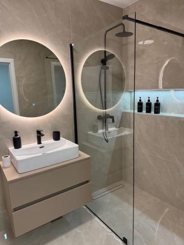 a bathroom with a sink and a shower at Apartman welsh in Bugojno