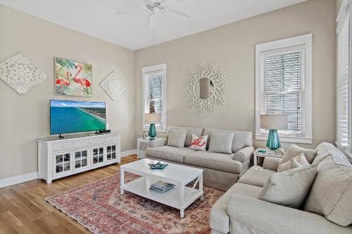 a living room with a couch and a tv at Shore Fun At Destin Pointe Resort in Destin