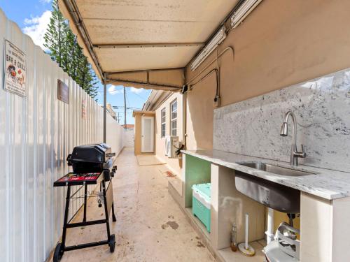 a kitchen with a sink and a counter in a trailer at Tropical Bay House-Near By Brickell, Wynwood and South Beach in Miami