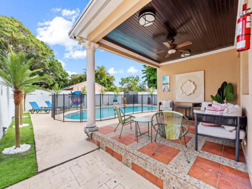 a patio with a table and chairs and a pool at Tropical Bay House-Near By Brickell, Wynwood and South Beach in Miami