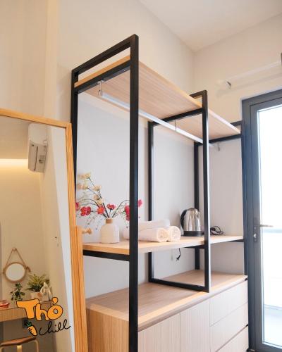 a black and wooden shelf in a kitchen at Thỏ Chill Homestay in Vung Tau