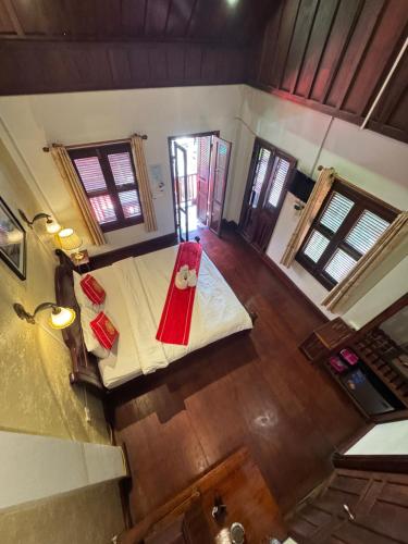 an overhead view of a room with a bed with a red blanket at Luangprabang Villa Kee Lee in Luang Prabang